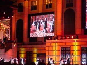 The ballroom dancers are onscreen, with ice skating dancers on the rink.